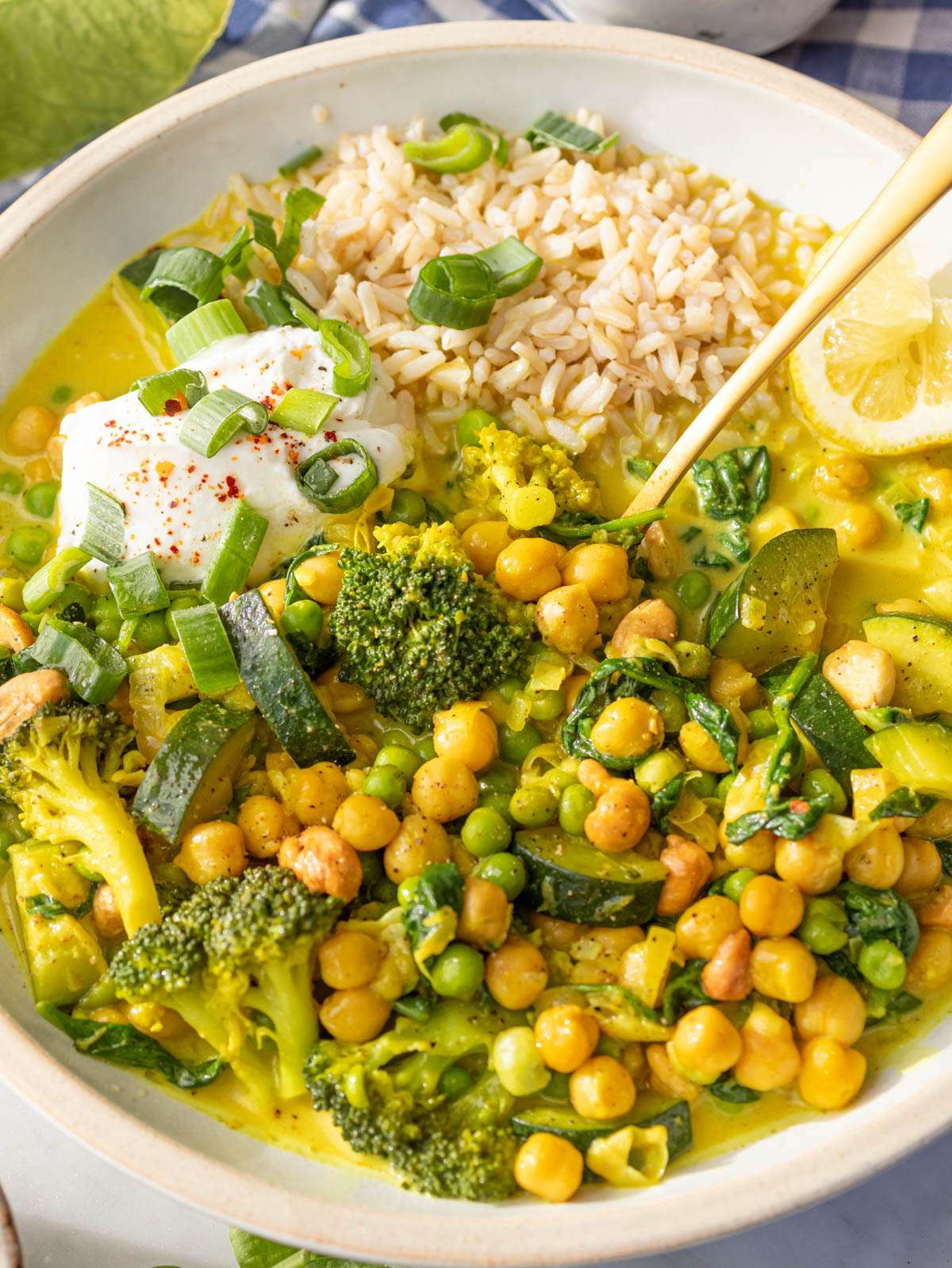 Close up creamy lemon vegetable curry with chickpeas and veggies in a cozy bowl.