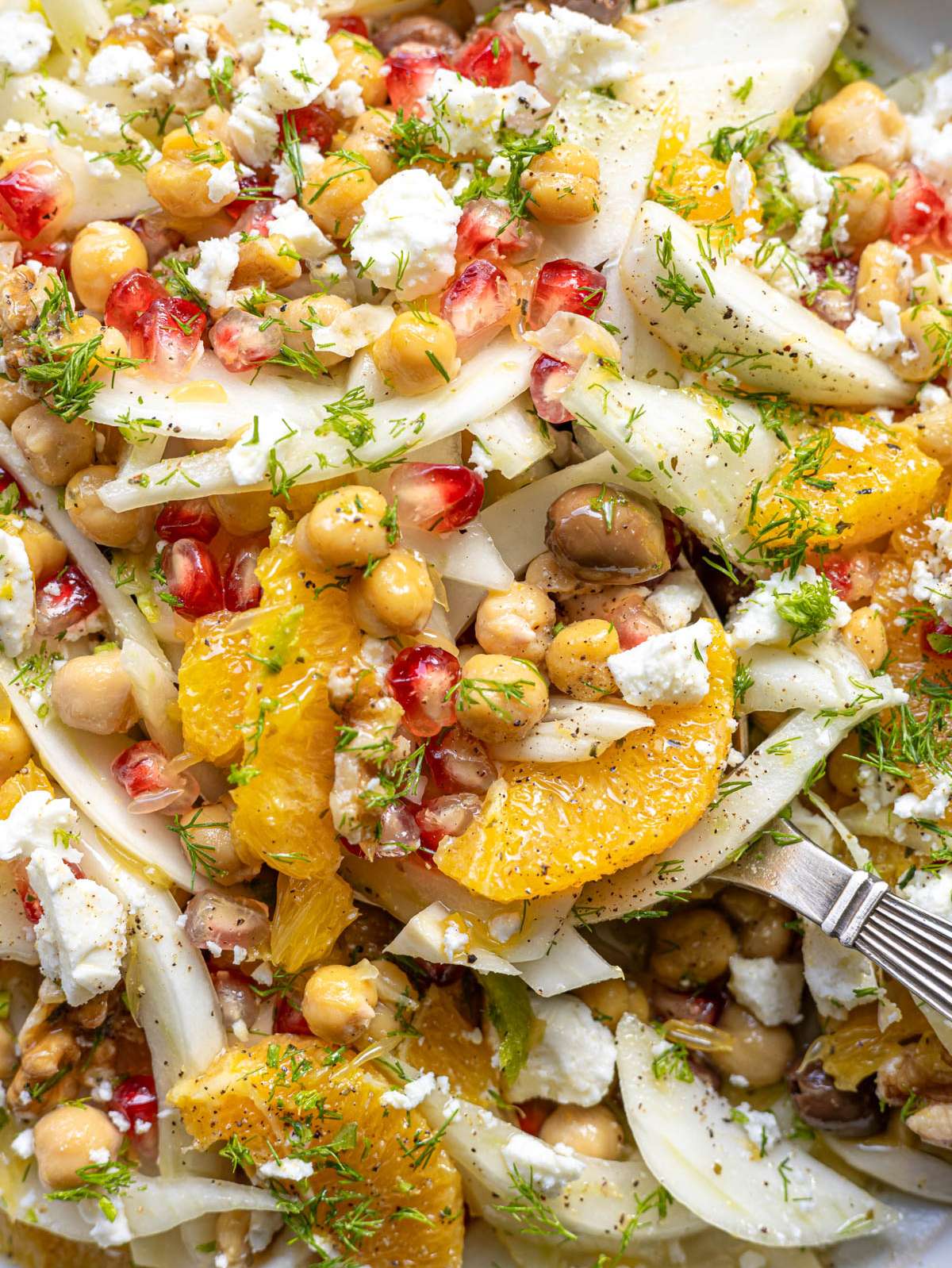 Close up orange fennel salad with chickpeas feta citrus dressing fresh Mediterranean textures.