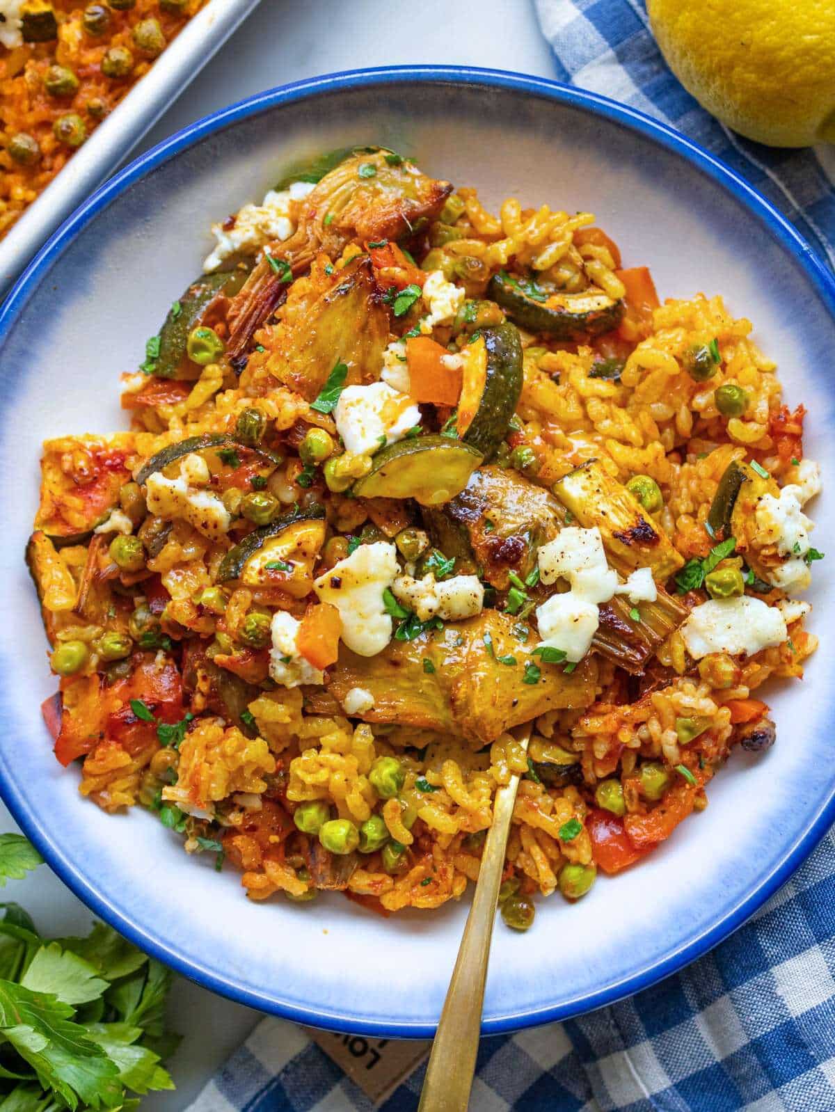 Easy Vegetable Paella in a bowl showing golden rice and colorful Mediterranean vegetables.