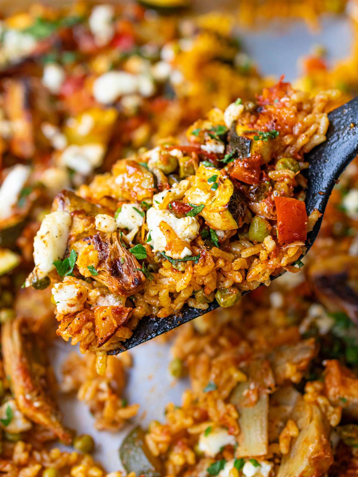 Finished dish close up Vegetable Paella with tender rice and roasted veggies on sheet pan.