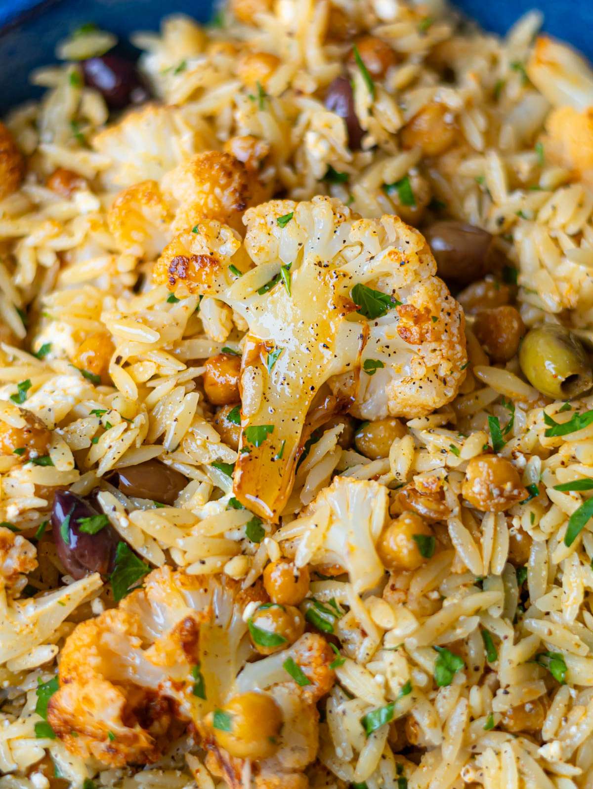 Finished dish close up showing roasted cauliflower orzo with feta and lemon.