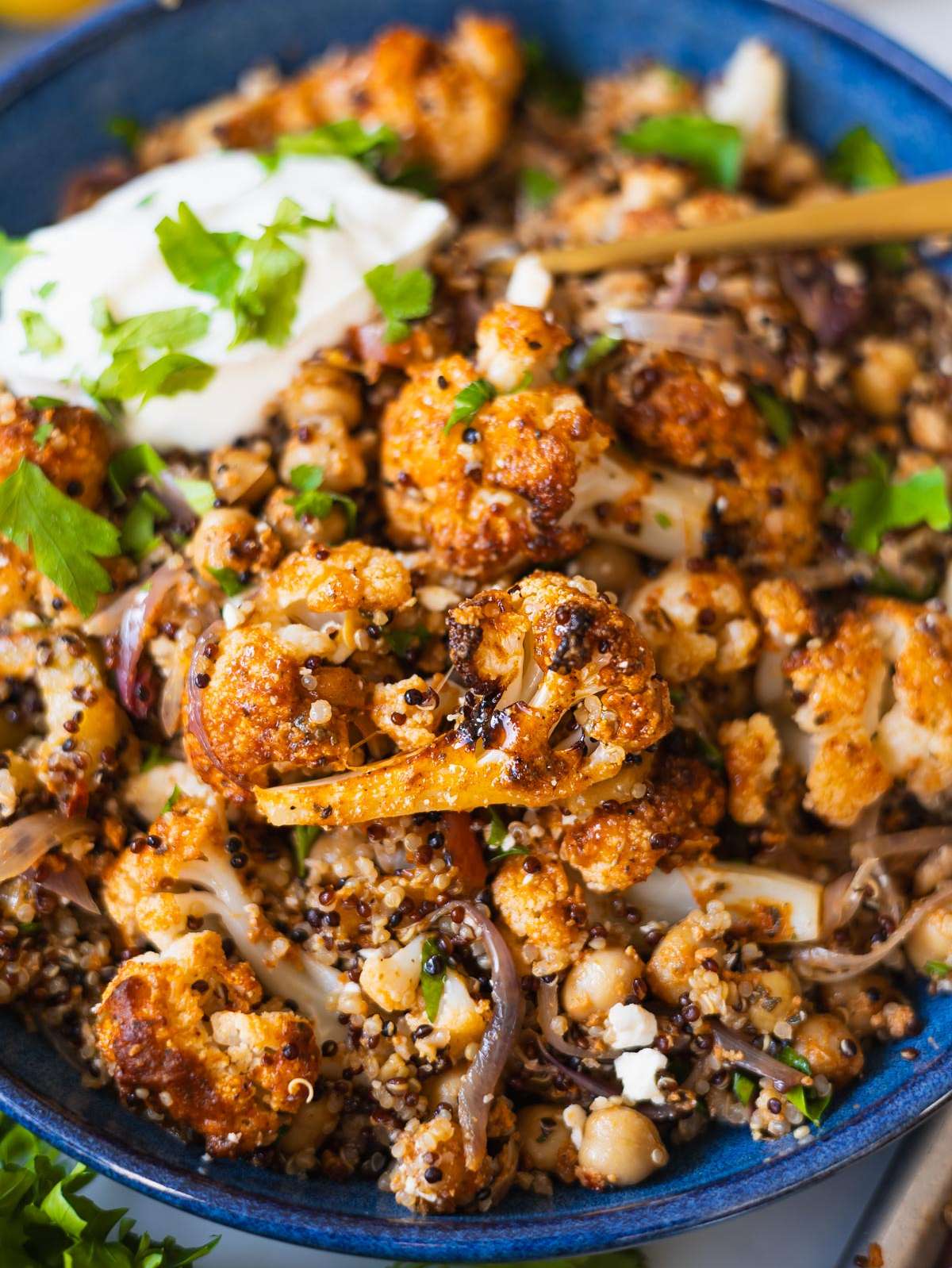Greek cauliflower bowl Gyros style with roasted vegetables grains and yogurt in a bowl.