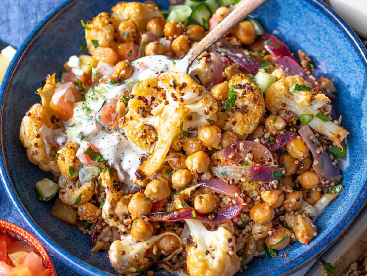 Healthy cauliflower shawarma bowl showing roasted cauliflower chickpeas onions and fresh Mediterranean flavors.