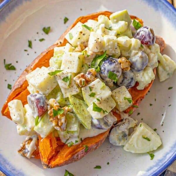 Healthy creamy waldorf salad on a baked sweet potato.