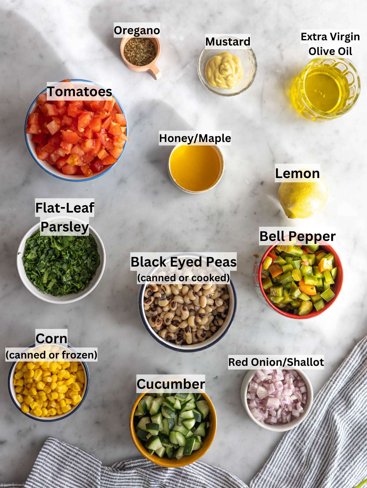 Ingredients for black eyed pea salad with beans vegetables herbs and lemon dressing.