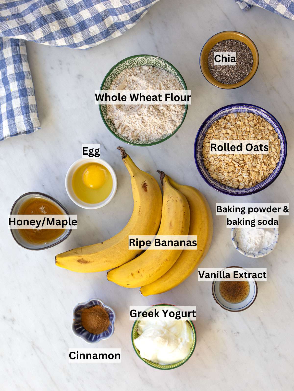 Ingredients for high fiber breakfast muffins with oats bananas yogurt and cinnamon.