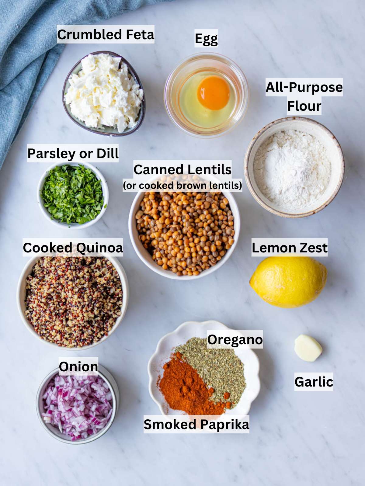 Ingredients for lentil quinoa patties including lentils quinoa herbs spices and feta.