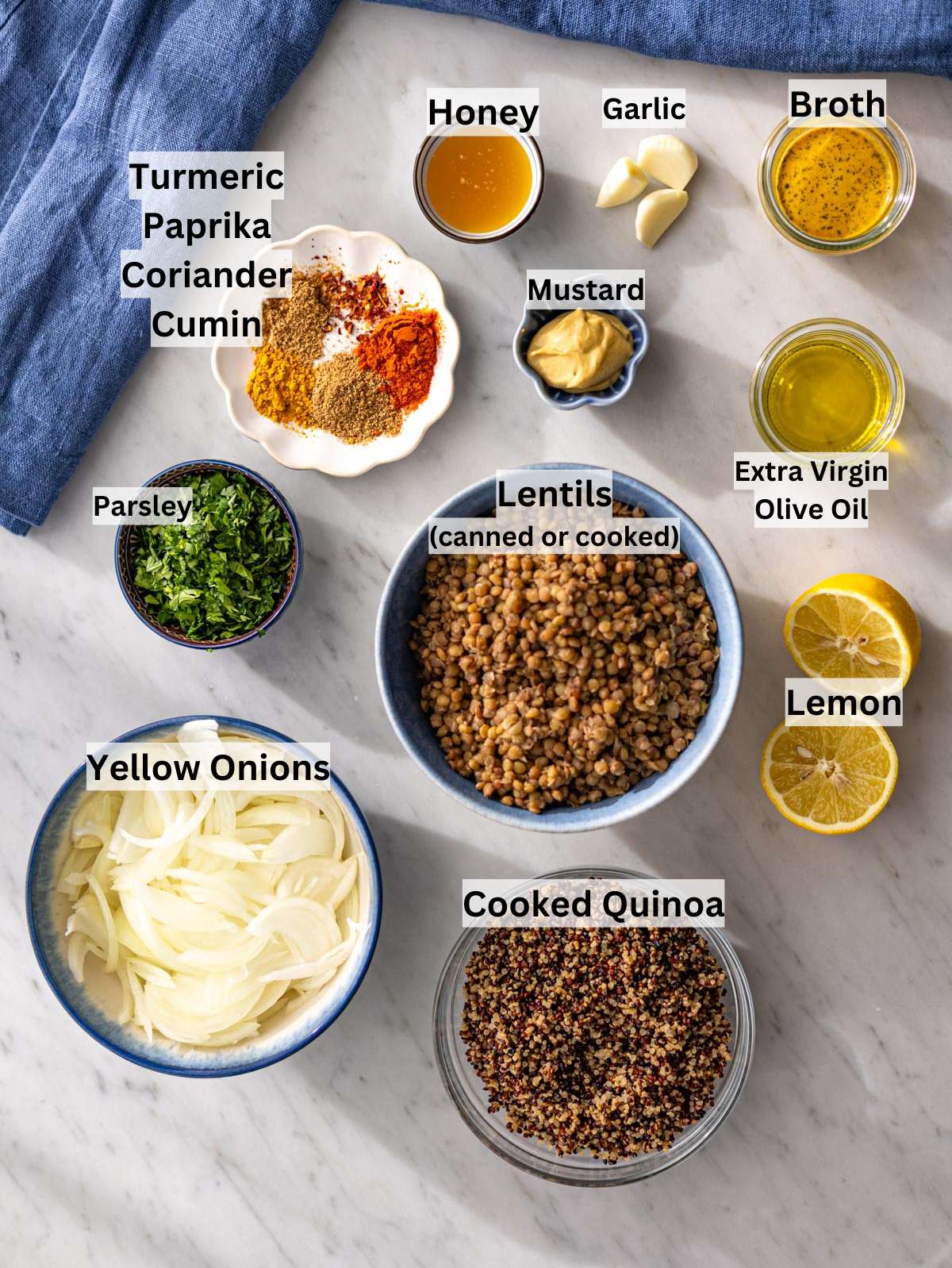 Ingredients for lentils and quinoa skillet arranged on marble surface before cooking.