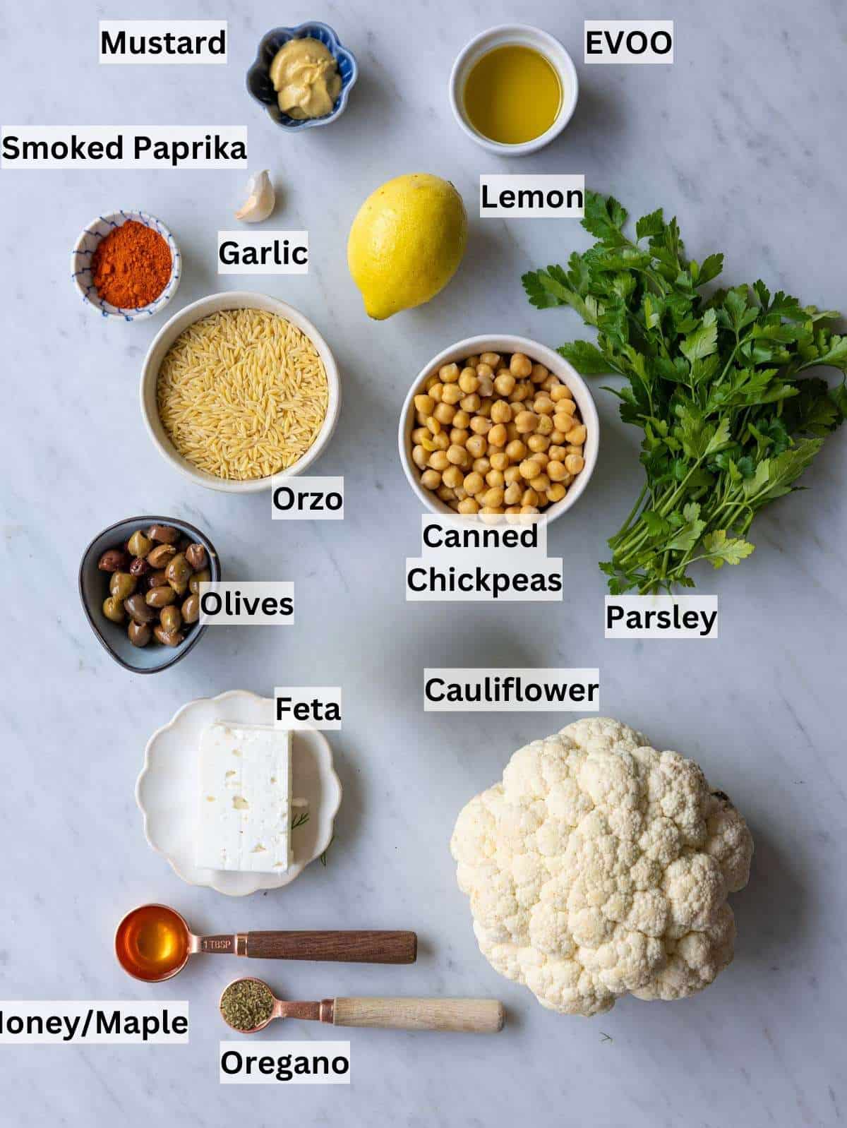 Ingredients laid out for easy roasted cauliflower orzo with chickpeas and lemon dressing.