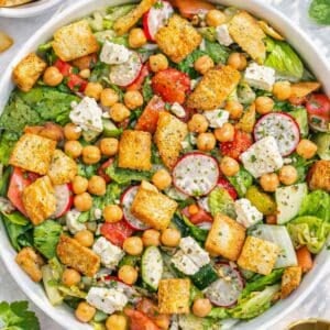 Mediterranean chopped pita salad with feta fresh vegetables and chickpeas ready to serve.