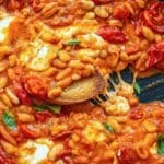 Skillet of pizza beans with melted cheese for an easy weeknight recipe.
