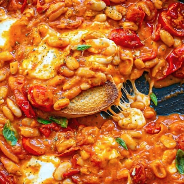 Skillet of pizza beans with melted cheese for an easy weeknight recipe.
