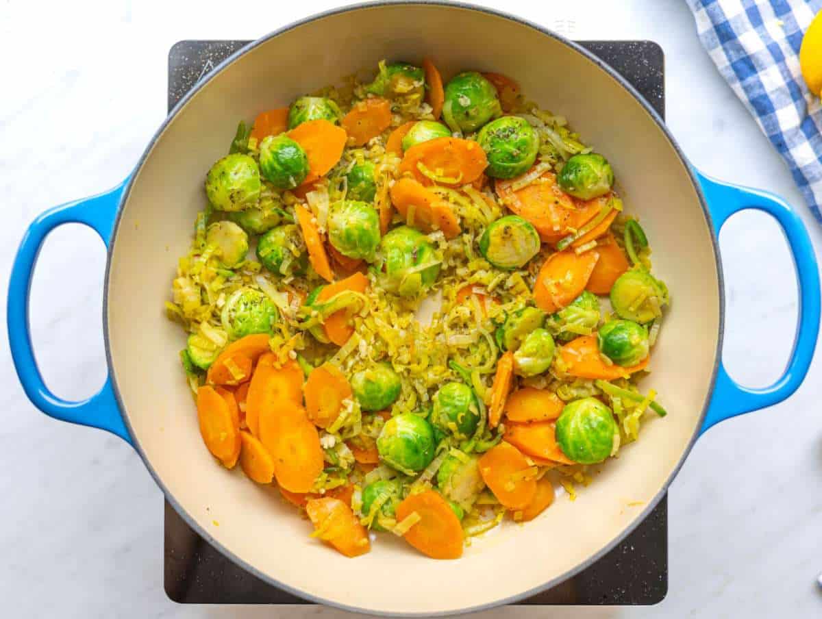 Step 1 Cooking leeks carrots and brussels sprouts in olive oil for vegetable orzo.