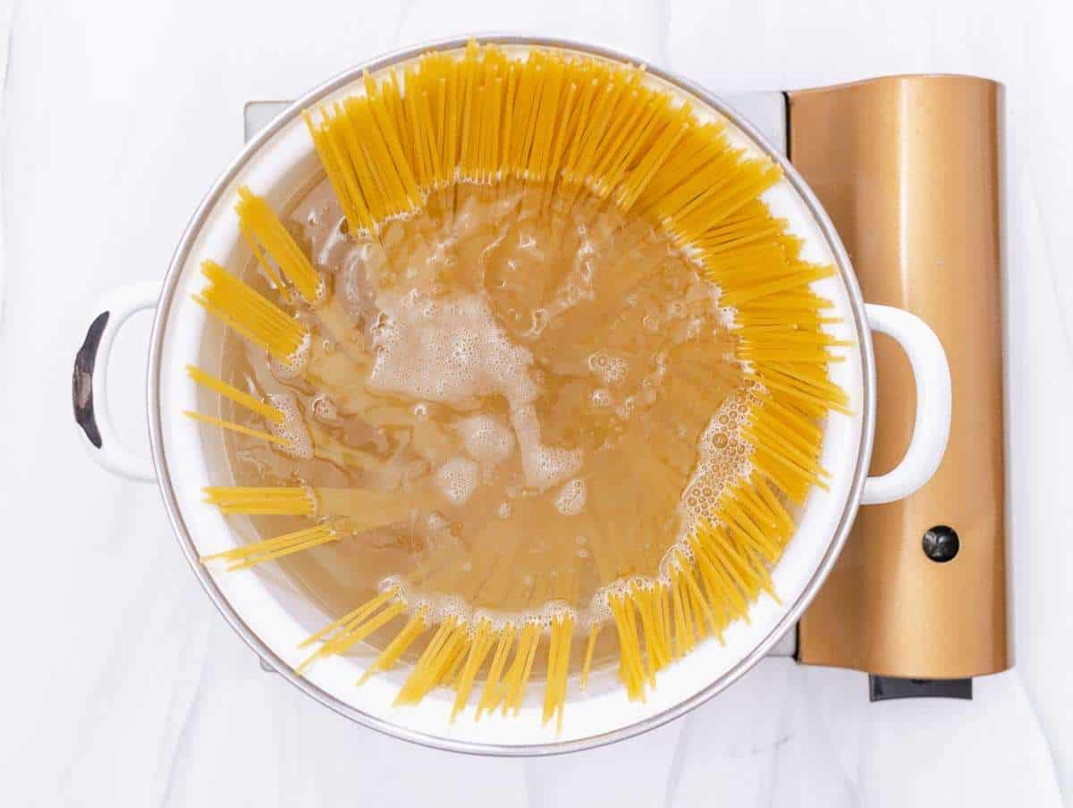 Step 1 Cooking spaghetti in salted water for an easy Italian pasta recipe.