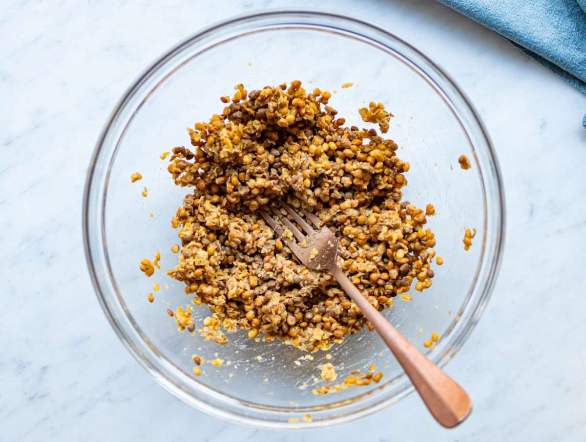 Step 1 Drained lentils mashed in a bowl to prepare base for patties.