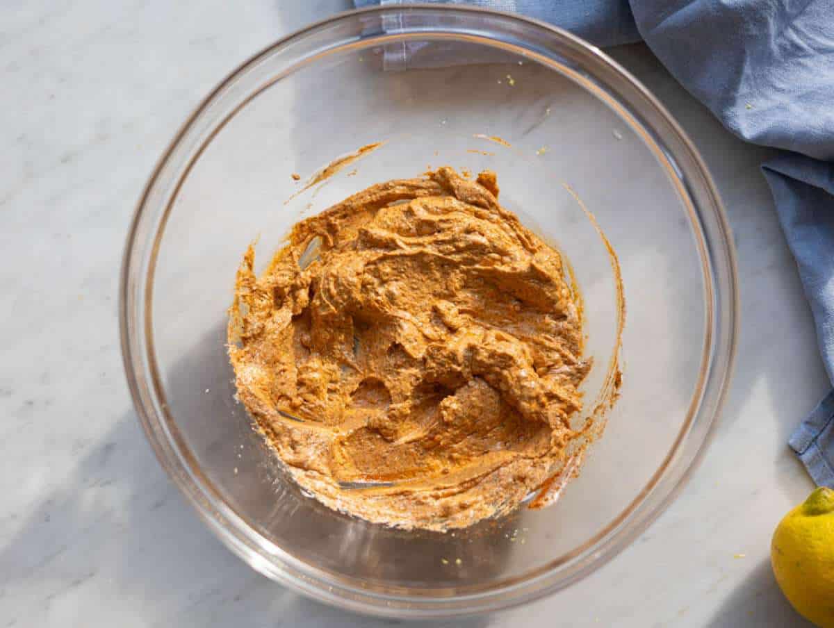 Step 1 Mixing Greek yogurt marinade with gyros spices in a bowl.