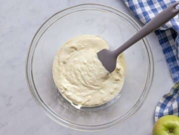 Step 1 Mixing creamy yogurt dressing for healthy Waldorf salad in a large bowl.