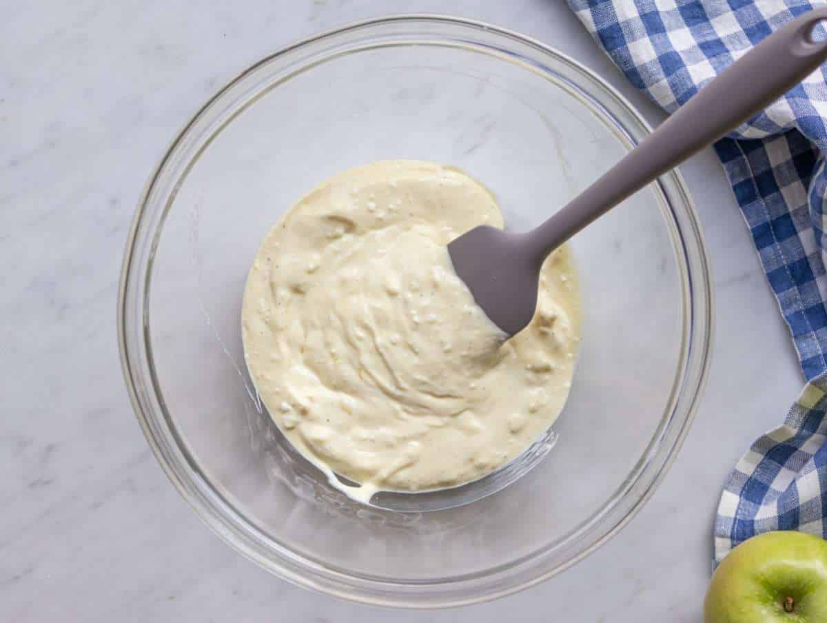 Step 1 Mixing creamy yogurt dressing for healthy Waldorf salad in a large bowl.