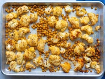 Step 1 Roasted cauliflower and chickpeas on sheet pan ready for Mediterranean orzo dinner.