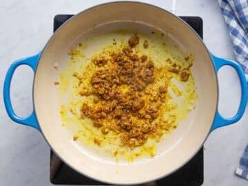 Step 1 Sautéing onions garlic ginger and spices for the curry base.