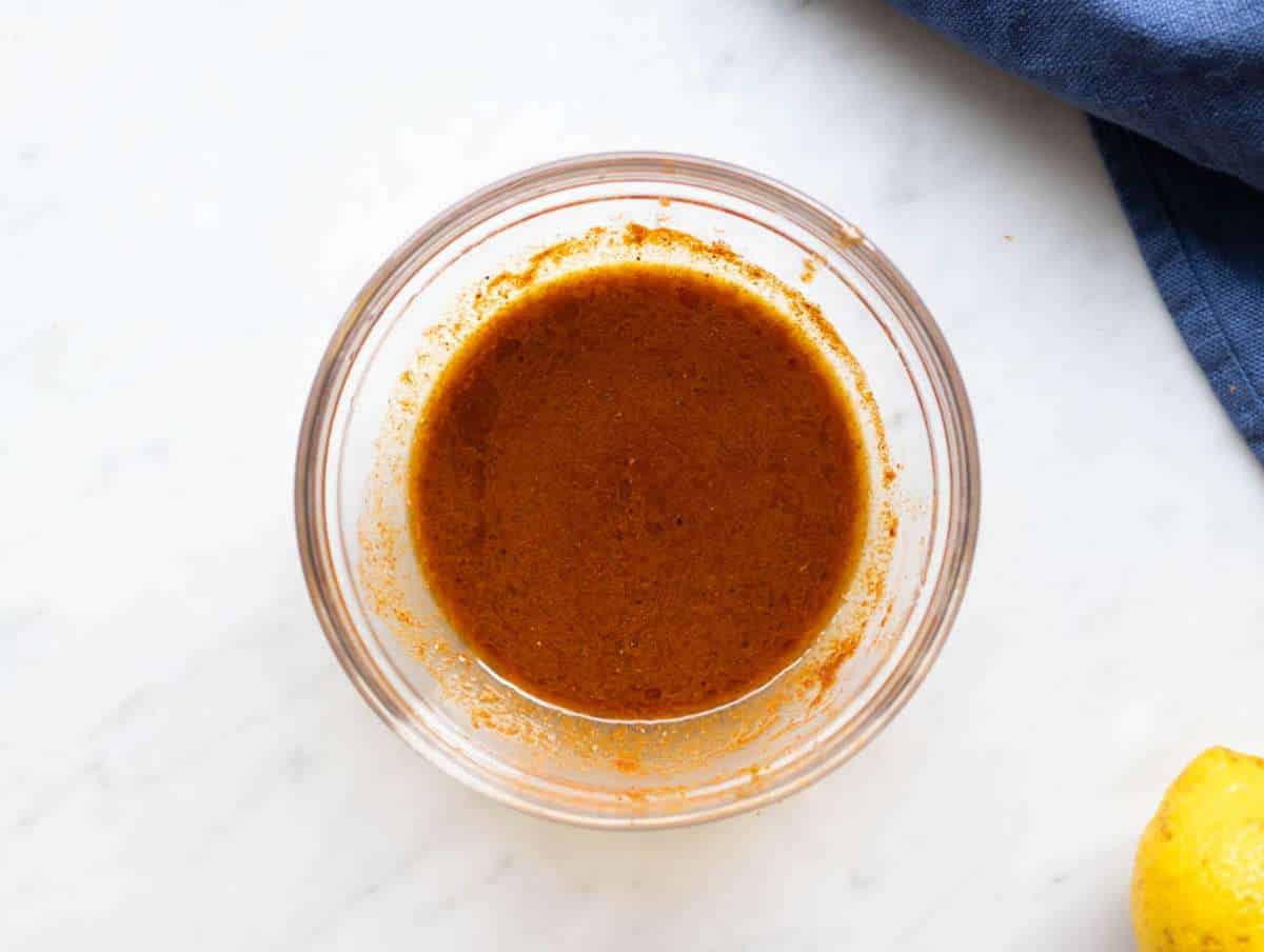 Step 1 Shawarma marinade for cauliflower shawarma bowl whisked with spices olive oil garlic and lemon.