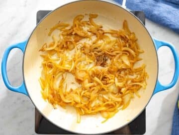 Step 1 Sliced onions caramelizing in skillet with olive oil and honey.