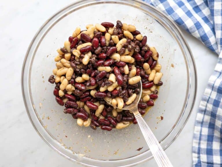 Step 1 Whisking dressing and mixing it with beans for quick bean marinade in large bowl.