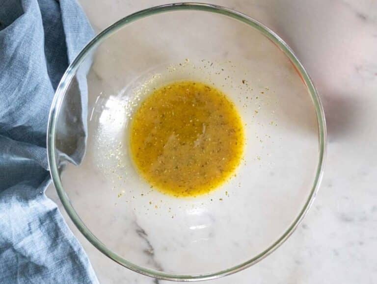 Step 1 Whisking lemon olive oil mustard dressing in a bowl for lentil salad.