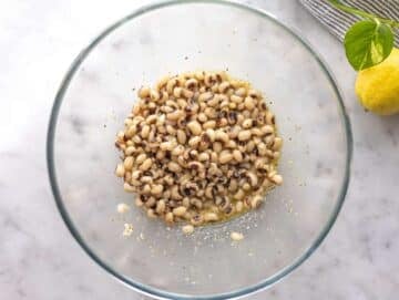Step 2 Black eyed peas marinating in lemon dressing for easy healthy bean salad.