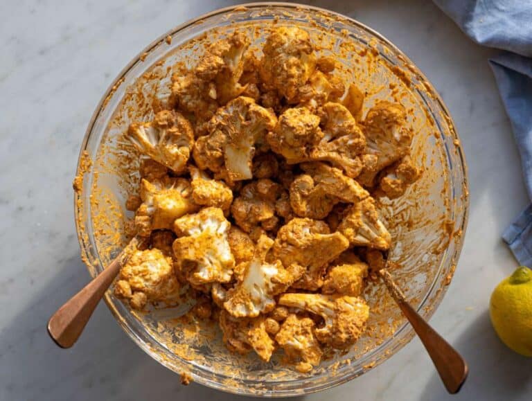 Step 2 Cauliflower and chickpeas coated in yogurt marinade before roasting.