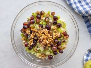 Step 2 Chopped apples celery and grapes tossed with dressing for healthy Waldorf salad.
