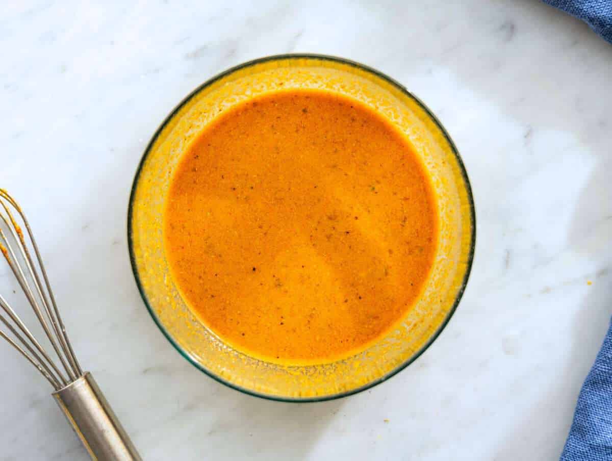 Step 2 Golden Mediterranean sauce whisked in bowl with spices lemon and olive oil.