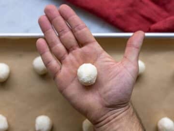Step 2 Shaping coconut macaroons by hand before baking on parchment lined tray.