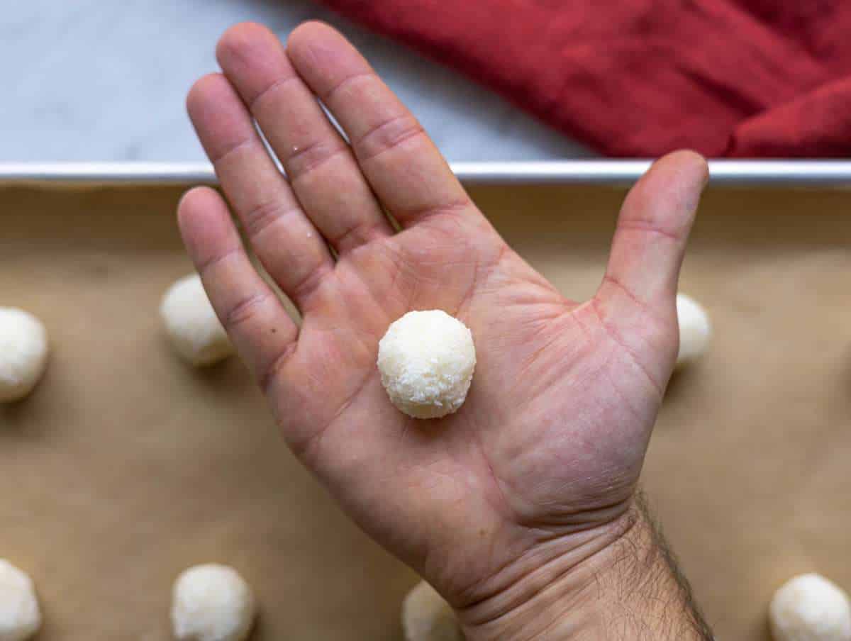 Step 2 Shaping coconut macaroons by hand before baking on parchment lined tray.