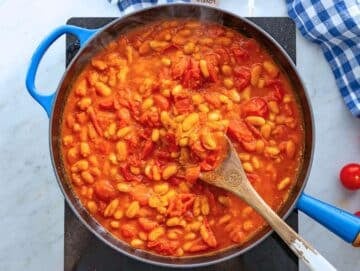 Step 2 Simmering cannellini beans and tomatoes together to create a rich saucy base.