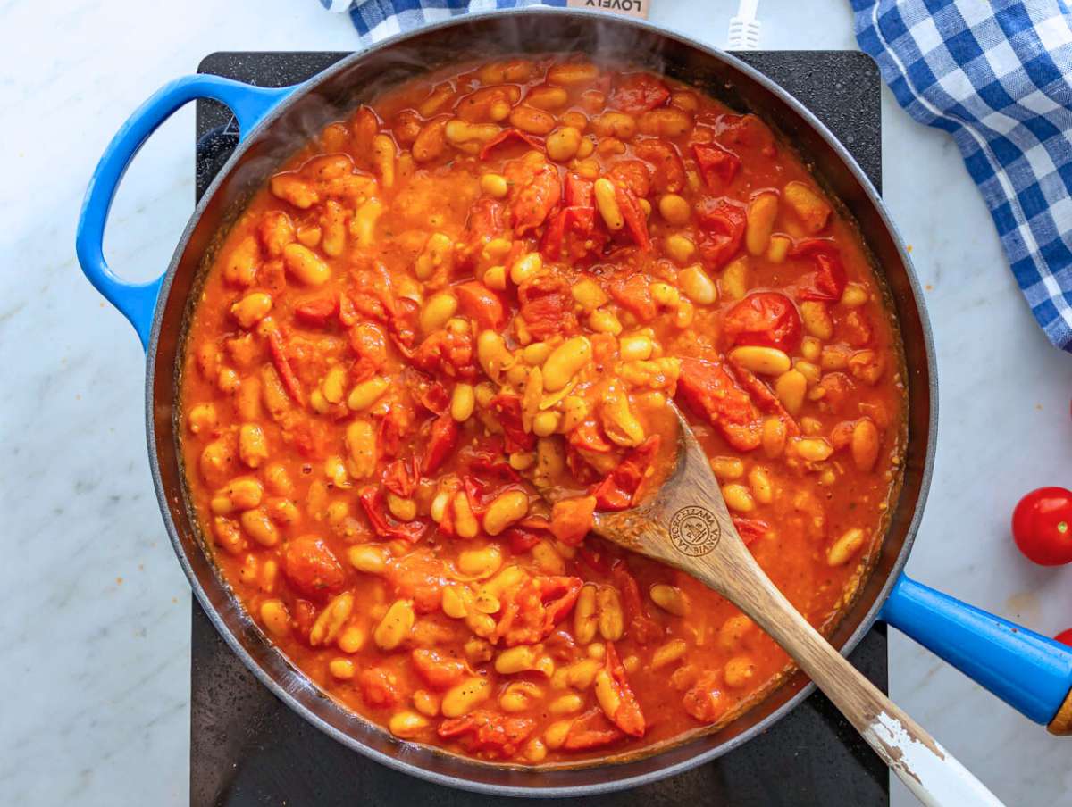 Step 2 Simmering cannellini beans and tomatoes together to create a rich saucy base.