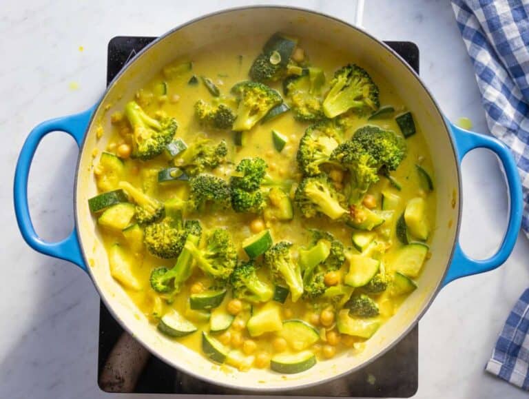Step 2 Simmering chickpeas zucchini and broccoli in coconut milk broth mixture.