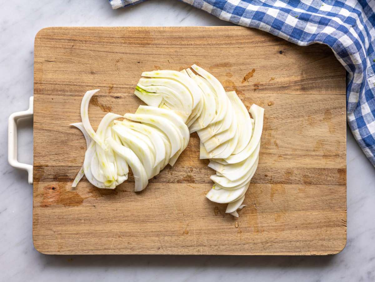 Step 2 Thinly slicing fennel for crisp Mediterranean salad base.