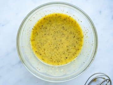 Step 2 Whisking lemon dressing for easy roasted cauliflower orzo meal.