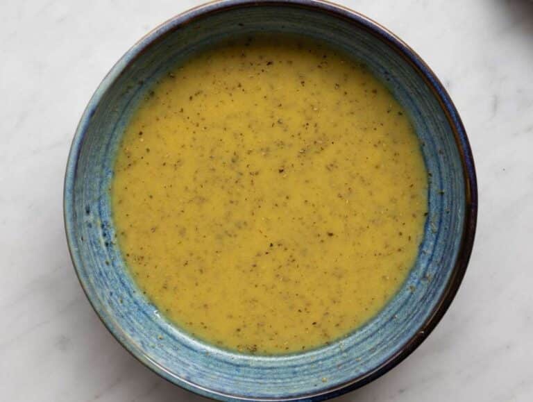 Step 2 Whisking olive oil dressing with vinegar mustard garlic and oregano in small bowl.