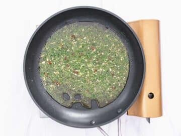 Step 3 Adding parsley to garlic oil to finish classic Italian pasta flavor.