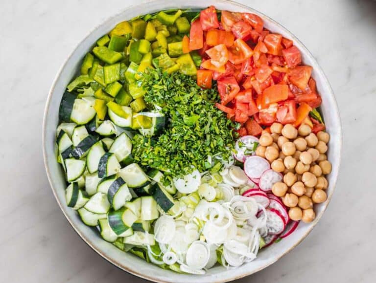 Step 3 Chopped vegetables and chickpeas added to bowl for pita salad base.