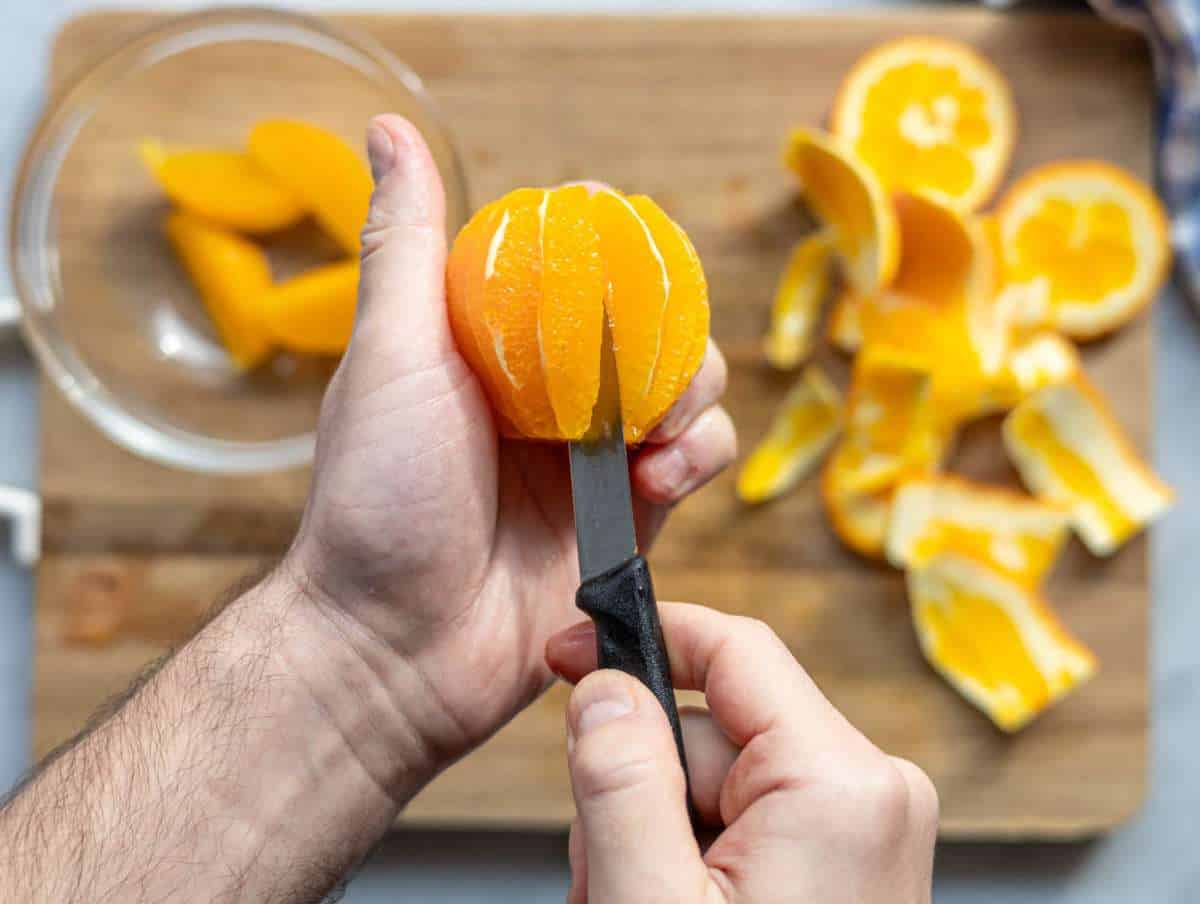 Step 3 Cutting oranges into juicy segments for citrus salad.