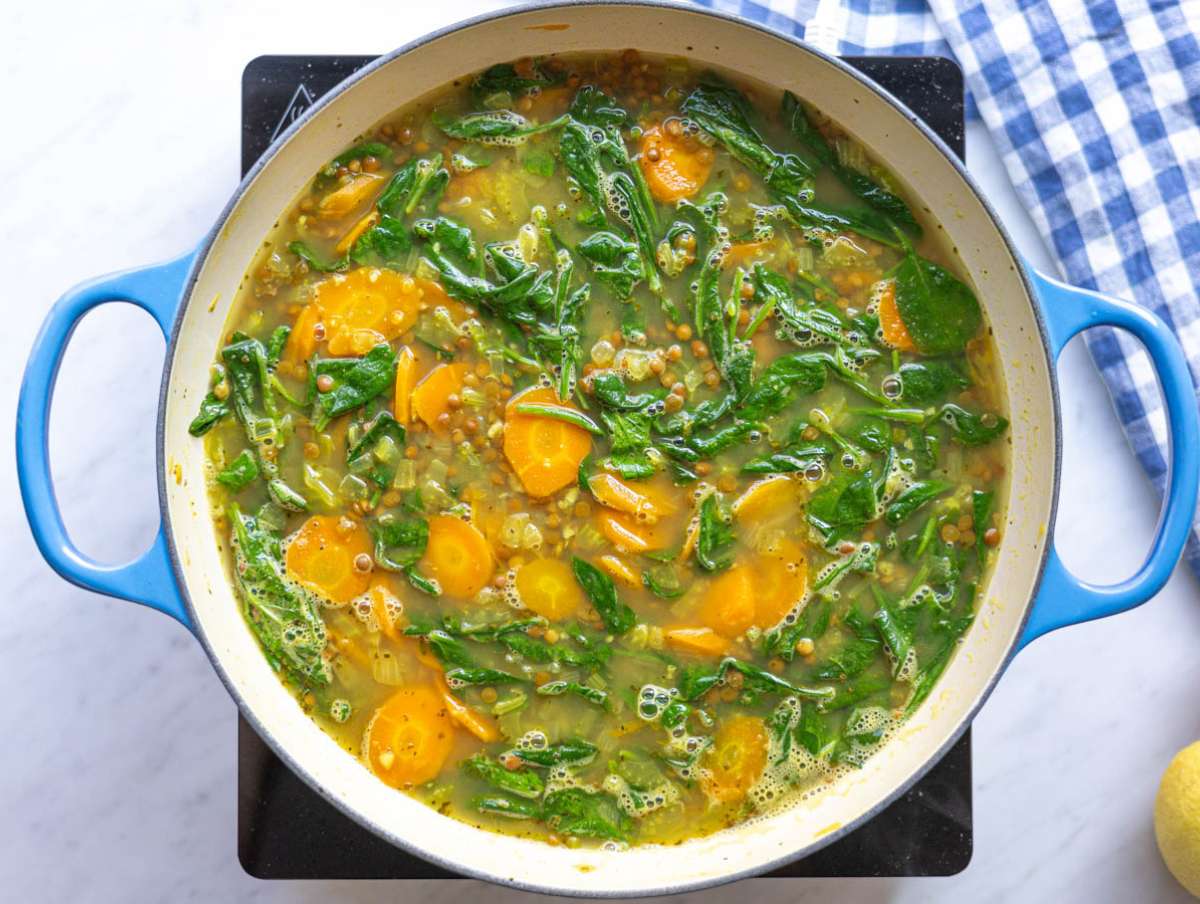 Step 3 Lemon lentil soup simmering gently on stove in large pot.