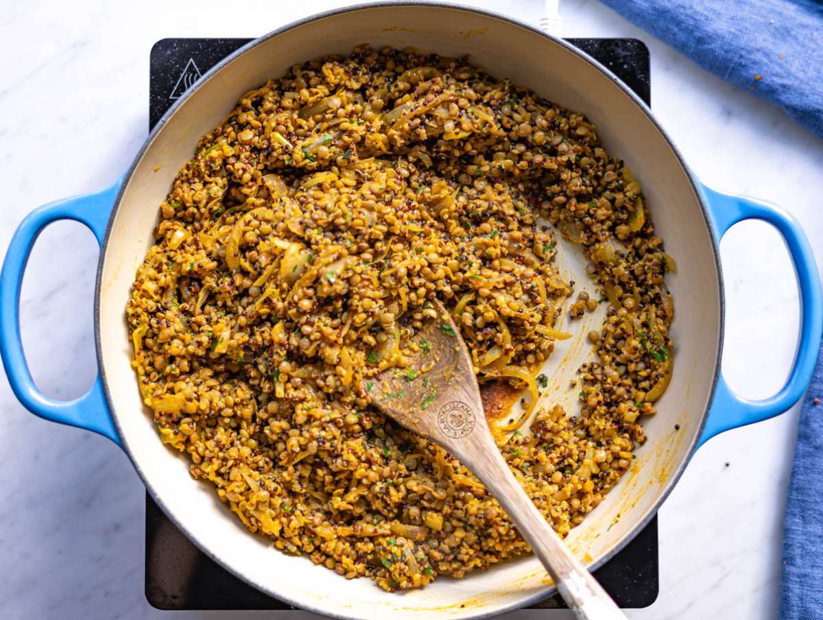Step 3 Lentils and quinoa added to skillet with onions and golden sauce.