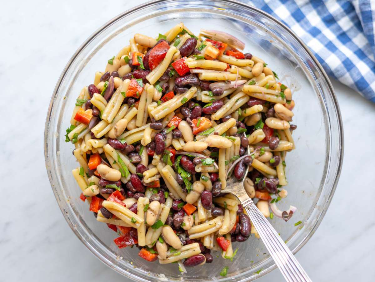 Step 3 Mixing pasta beans vegetables and herbs together in bowl.