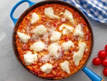 Step 3 Mozzarella and parmesan before melting under broiler on top of saucy beans in oven safe skillet.