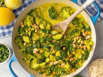 Step 3 Stirring peas and spinach into creamy simmered vegetable curry.