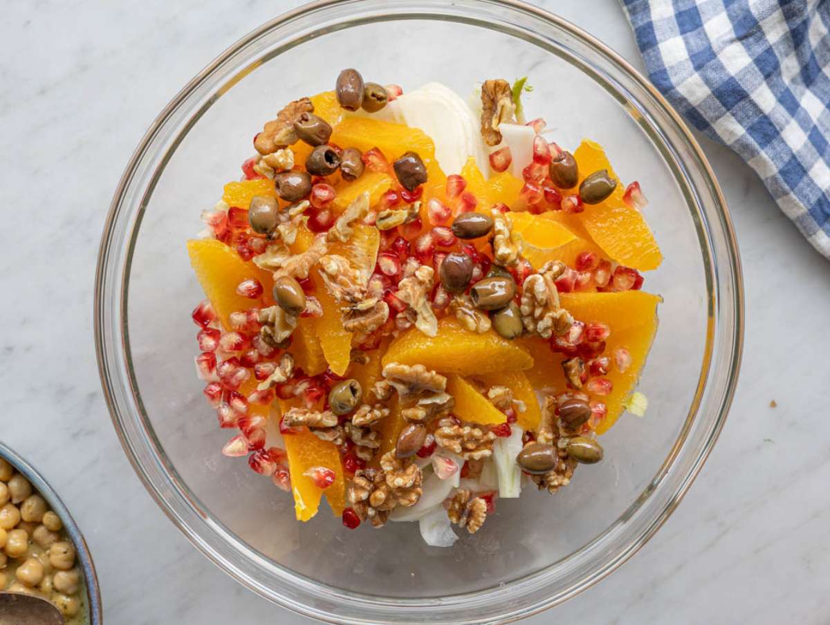 Step 4 Adding pomegranate walnuts and olives to salad bowl.