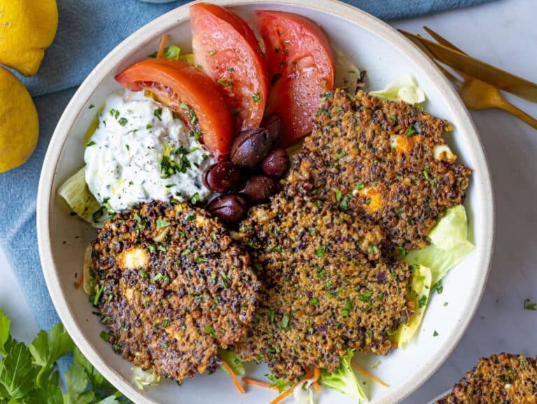 Step 4 Cooked patties served in a bowl with tzatziki olives and tomatoes.
